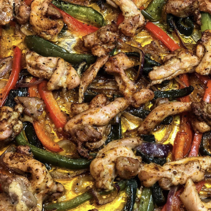 Ready-to-roast sheet pan chicken fajitas with red onion, bell + poblano peppers